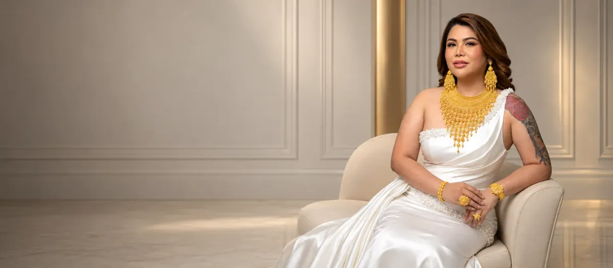 Miss Kim in an ivory gown wearing a gold necklace set