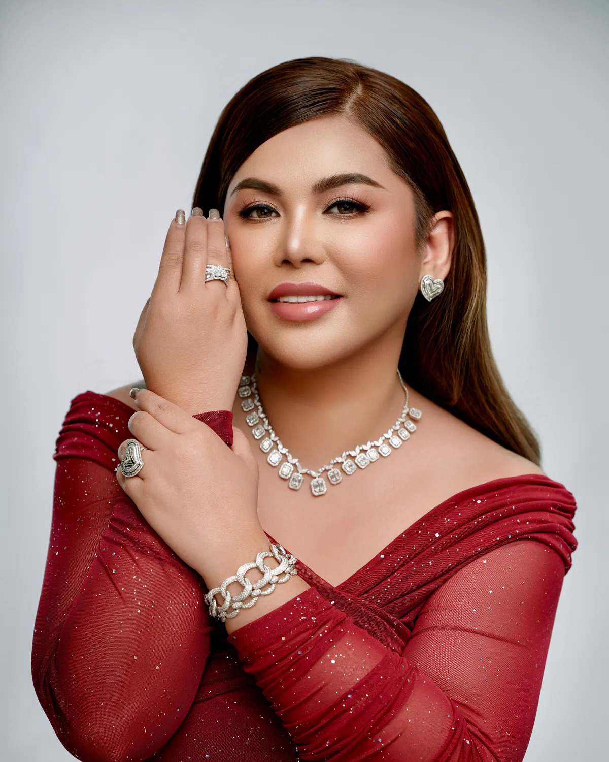 Miss Kim in a red gown wearing diamond jewellery